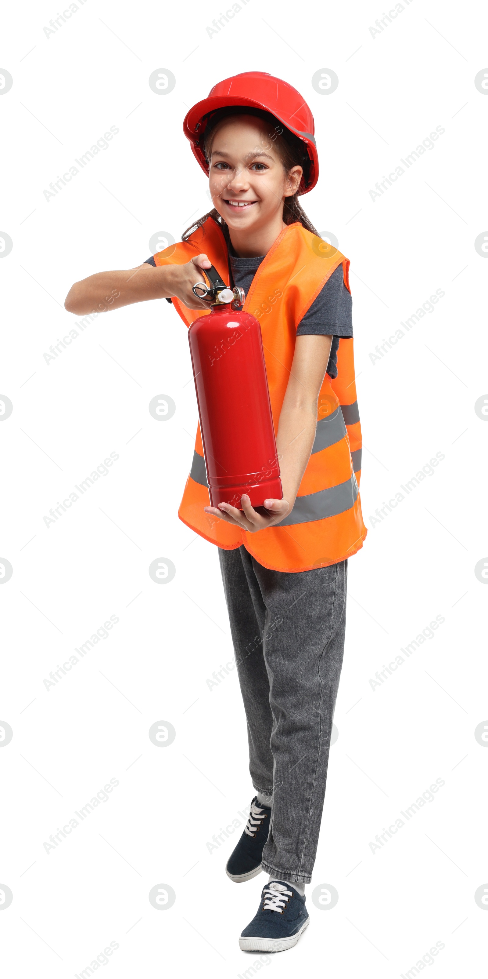 Photo of Girl with hardhat, fire extinguisher and vest pretending to be firefighter on white background. Dreaming of future profession