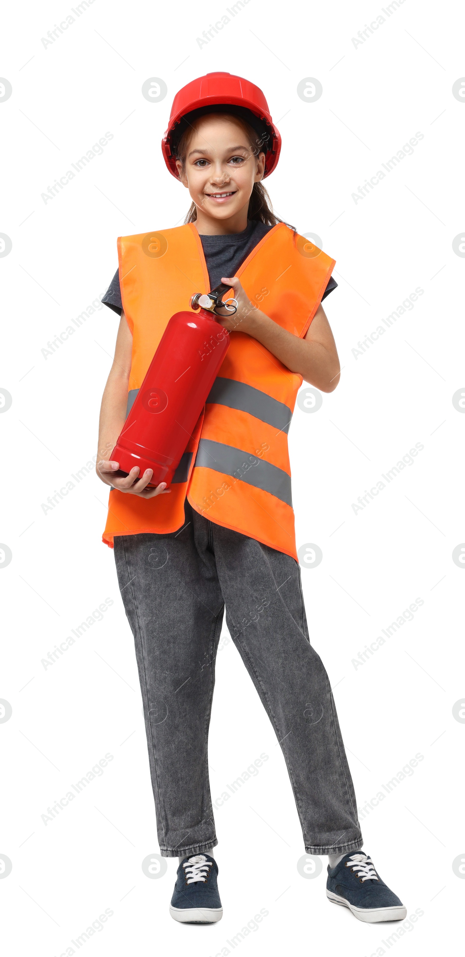 Photo of Girl with hardhat, fire extinguisher and vest pretending to be firefighter on white background. Dreaming of future profession