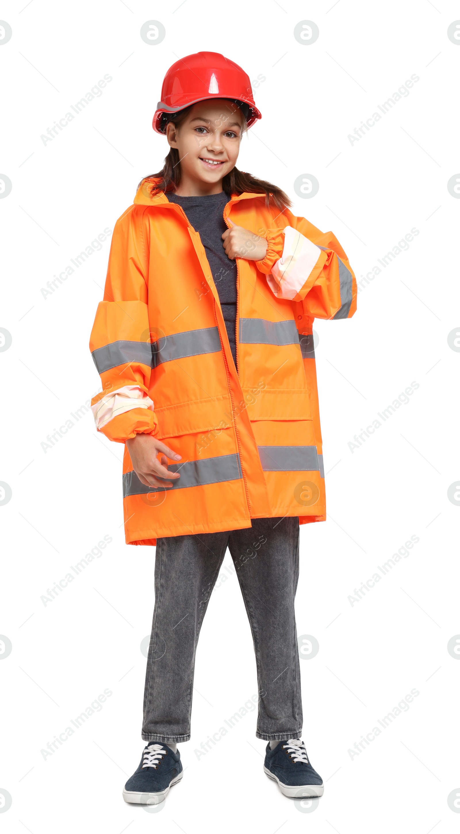 Photo of Girl with hardhat and vest pretending to be firefighter on white background. Dreaming of future profession