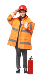 Photo of Girl with hardhat, fire extinguisher and vest pretending to be firefighter on white background. Dreaming of future profession