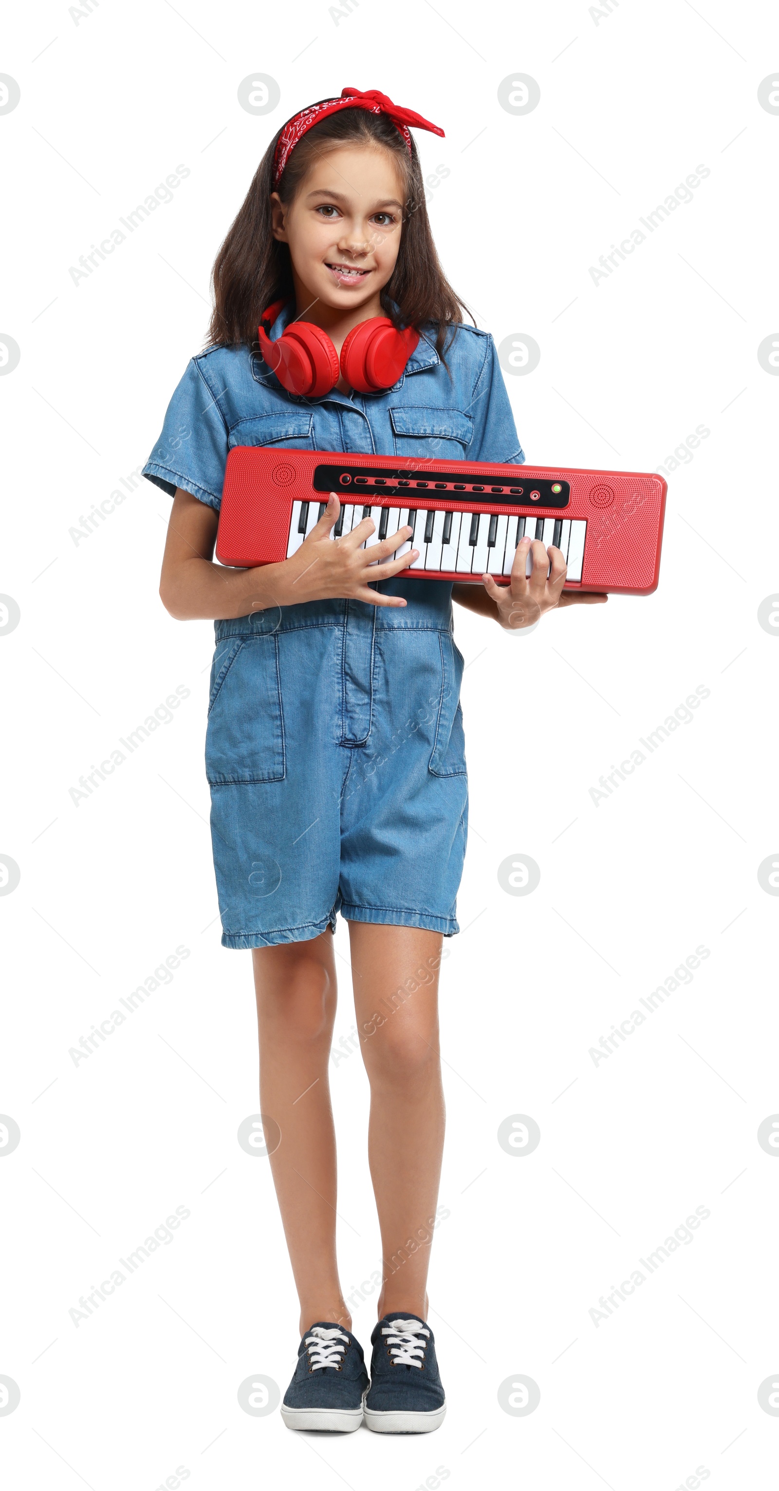 Photo of Girl with headphones and electric piano pretending to be musician on white background. Dreaming of future profession