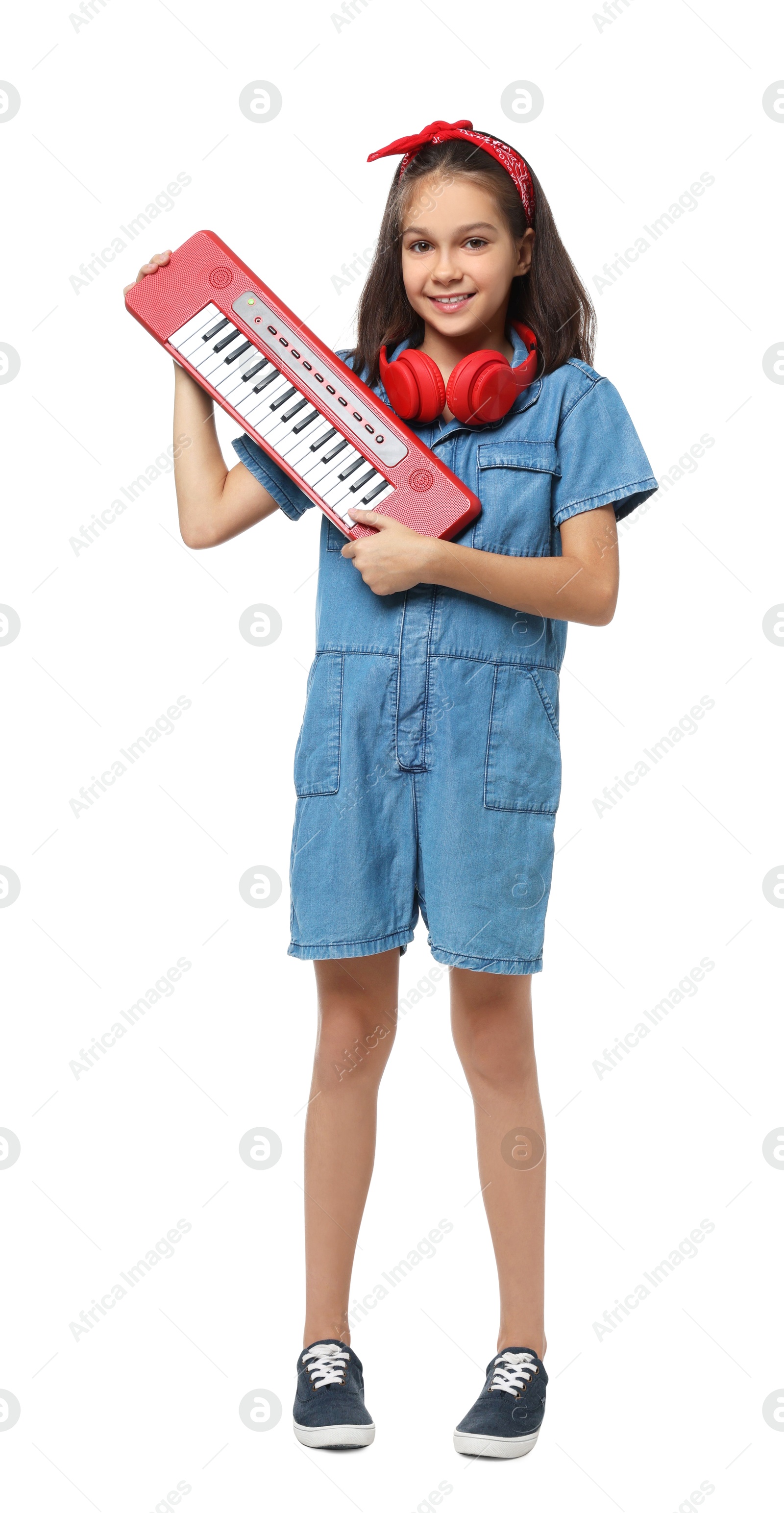 Photo of Girl with headphones and electric piano pretending to be musician on white background. Dreaming of future profession