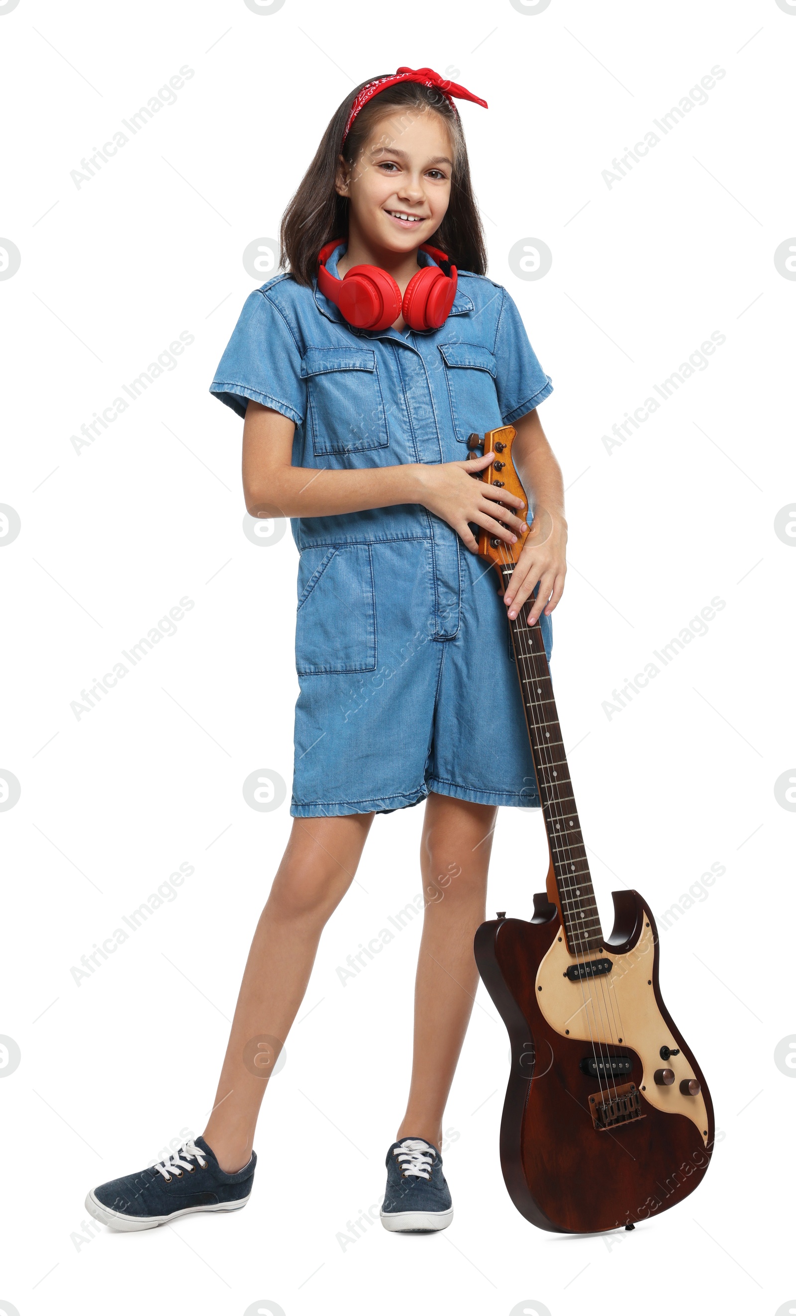 Photo of Girl with headphones and guitar pretending to be musician on white background. Dreaming of future profession