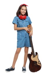 Girl with headphones and guitar pretending to be musician on white background. Dreaming of future profession