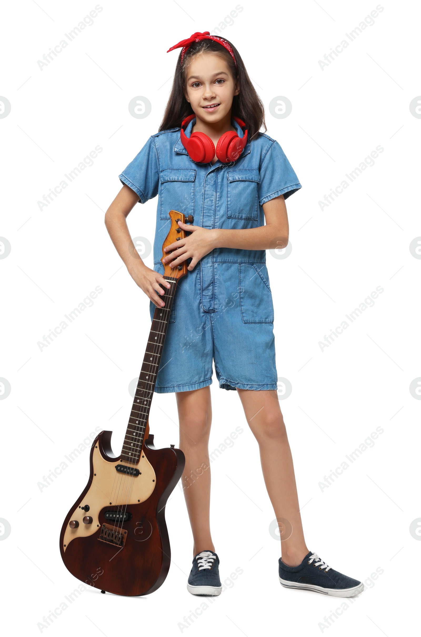 Photo of Girl with headphones and guitar pretending to be musician on white background. Dreaming of future profession