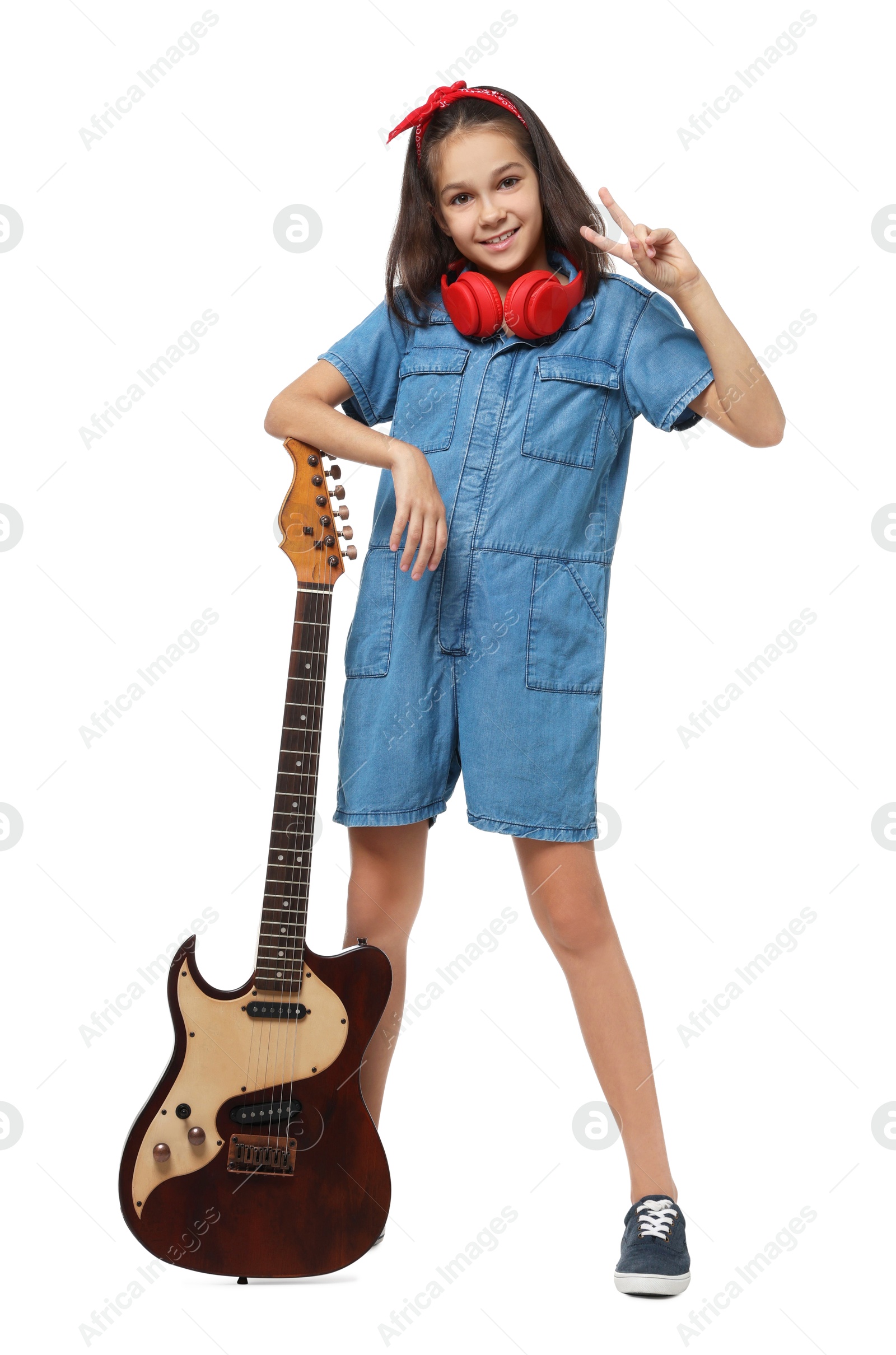 Photo of Girl with headphones and guitar pretending to be musician on white background. Dreaming of future profession