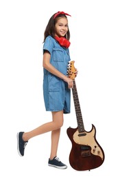 Photo of Girl with headphones and guitar pretending to be musician on white background. Dreaming of future profession