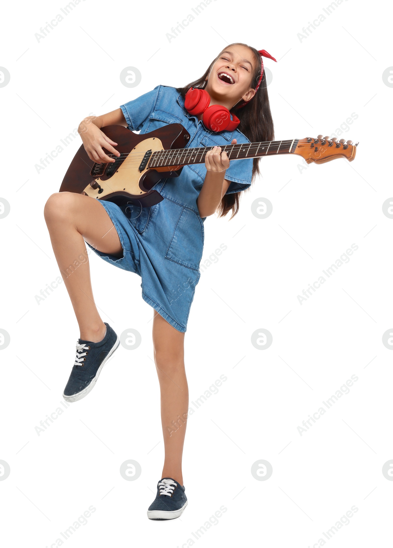 Photo of Girl with headphones and guitar pretending to be musician on white background. Dreaming of future profession