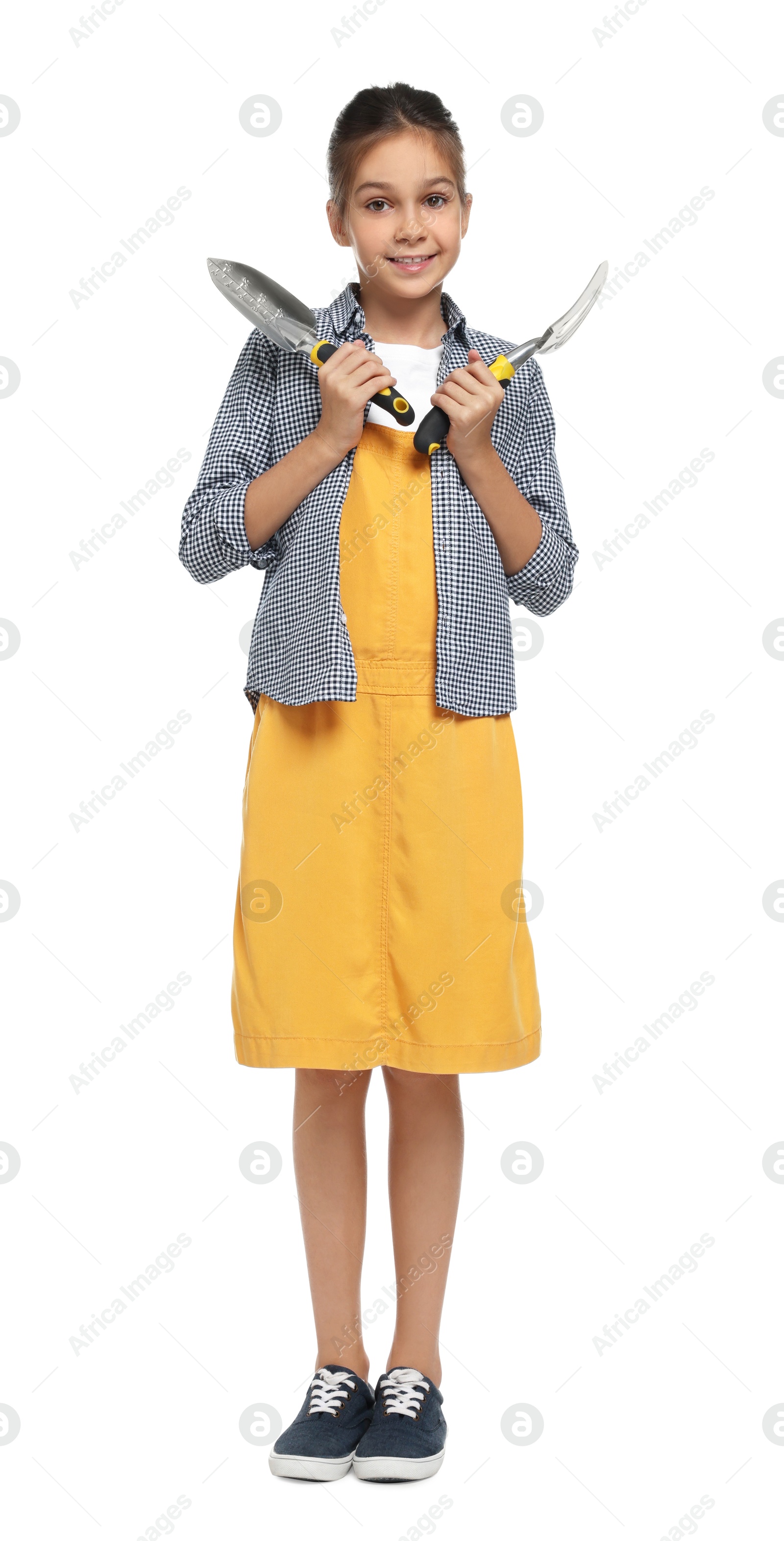 Photo of Girl with tools pretending to be gardener on white background. Dreaming of future profession