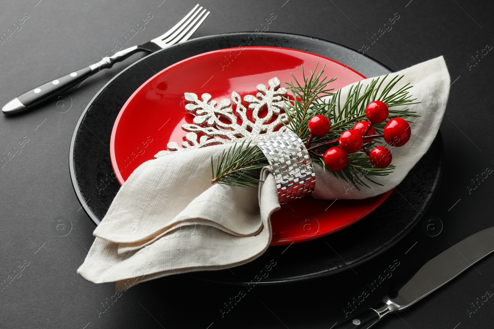 Photo of Christmas setting with festive decor on dark table, closeup