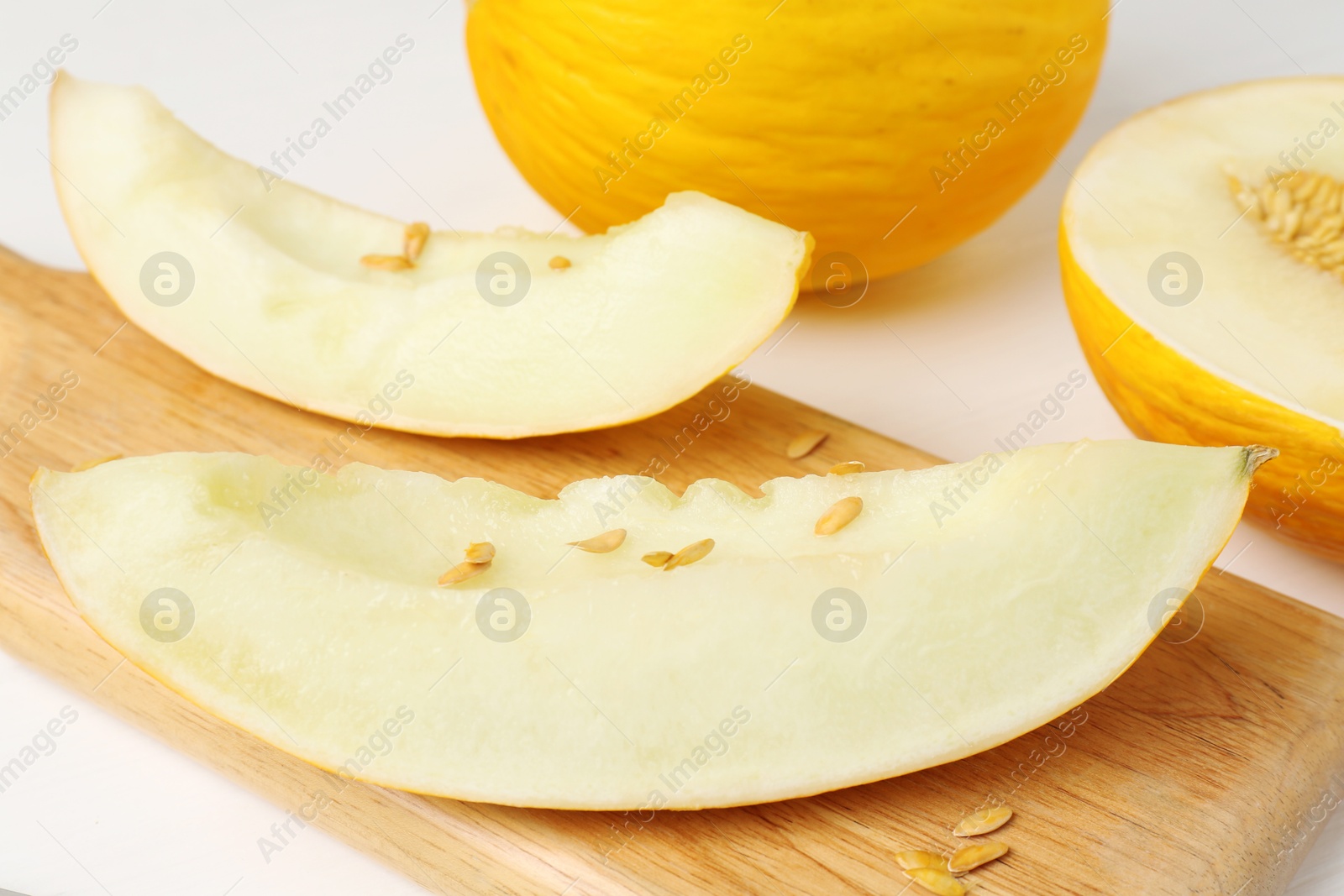 Photo of Fresh ripe melons on white table, closeup