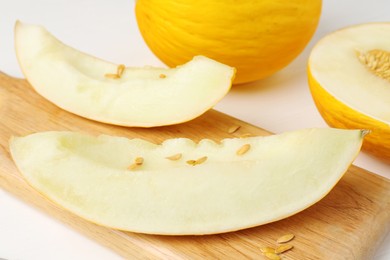 Photo of Fresh ripe melons on white table, closeup