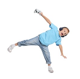 Photo of Little boy in headphones with controller on white background