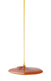 Photo of Tasty caramel sauce dripping on white background, closeup