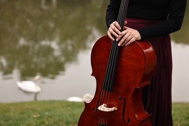 Photo of Woman with cello in park, closeup. Space for text