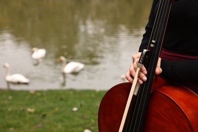 Photo of Woman with cello in park, closeup. Space for text