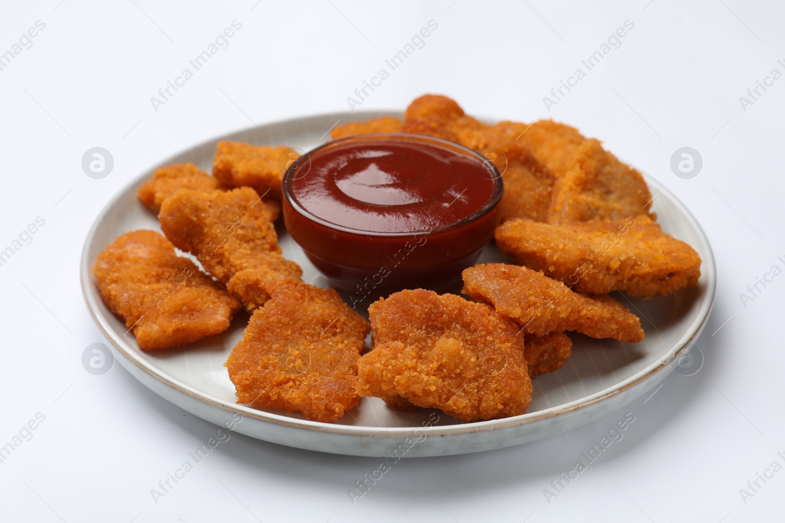 Photo of Delicious chicken nuggets with ketchup on white background