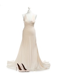 Photo of Mannequin with beautiful wedding dress and shoes isolated on white