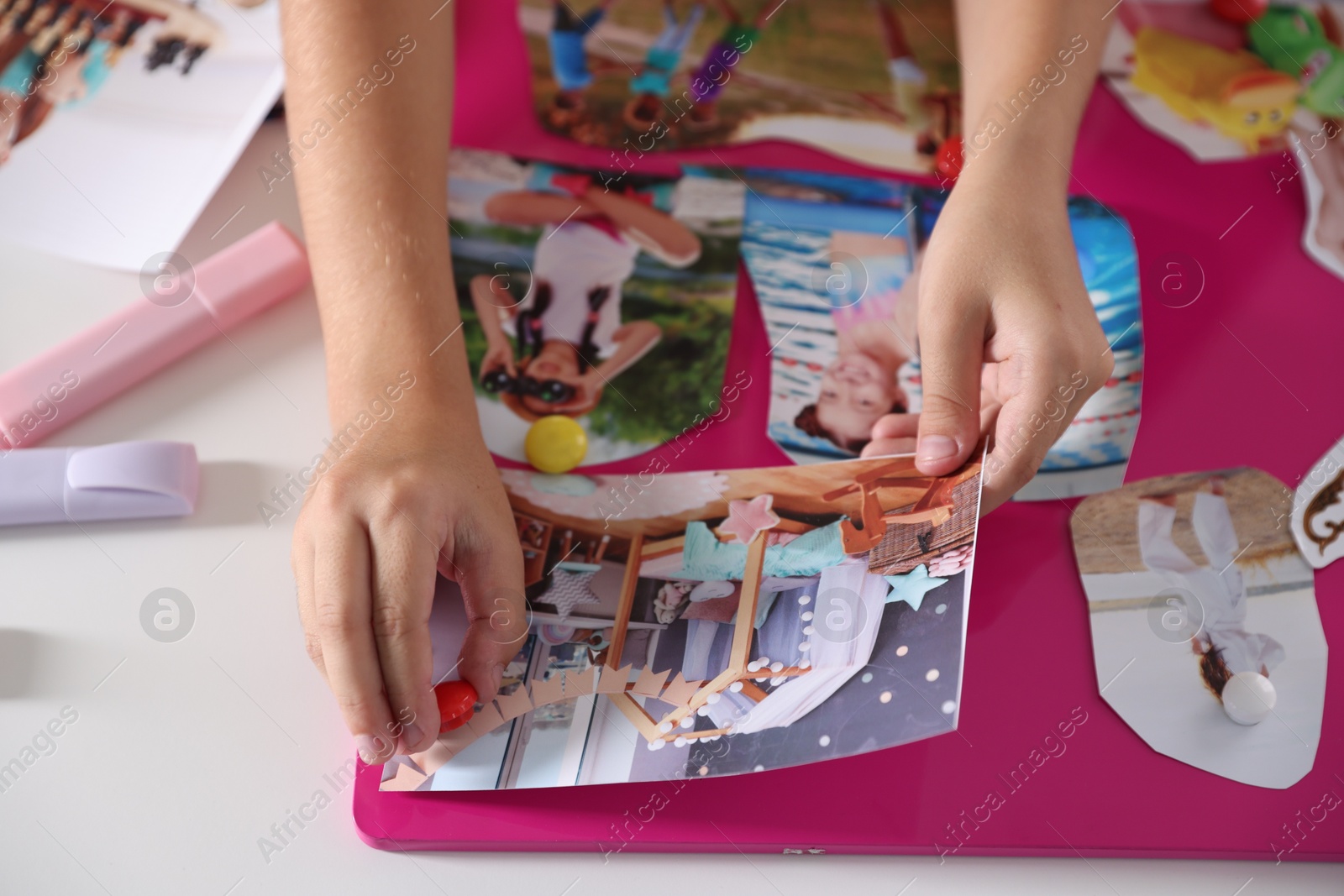 Photo of Creating vision board with different pictures at light table, closeup