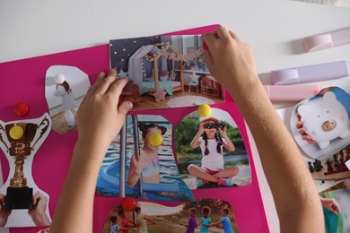 Girl creating vision board with different pictures at light table, top view