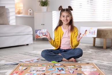 Creating vision board. Girl with picture on floor indoors