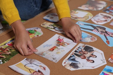 Photo of Girl creating vision board with different pictures, closeup