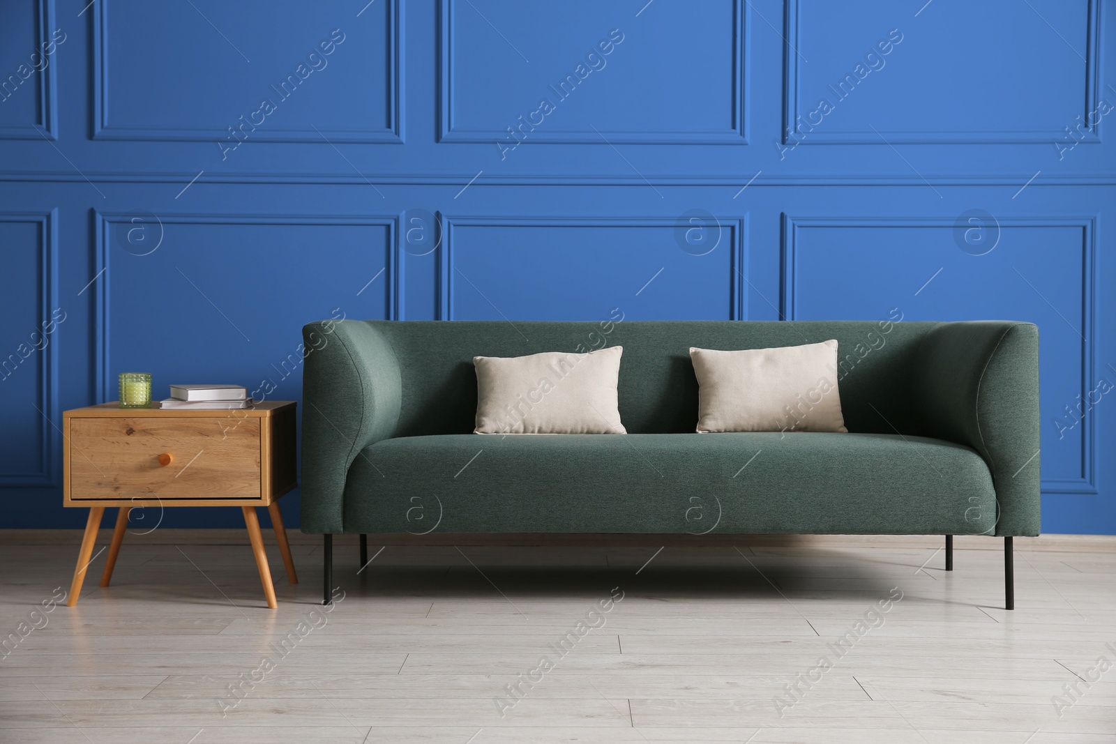 Image of Comfortable sofa and side table near blue wall in room