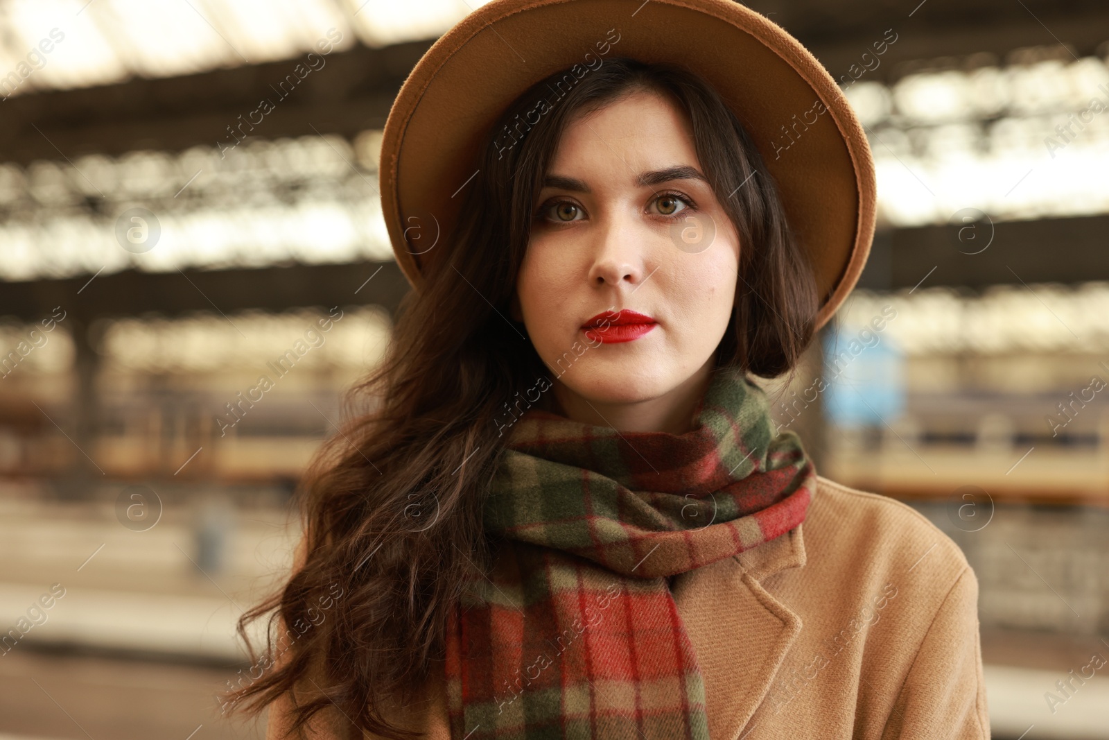 Photo of Beautiful woman in hat at railway station