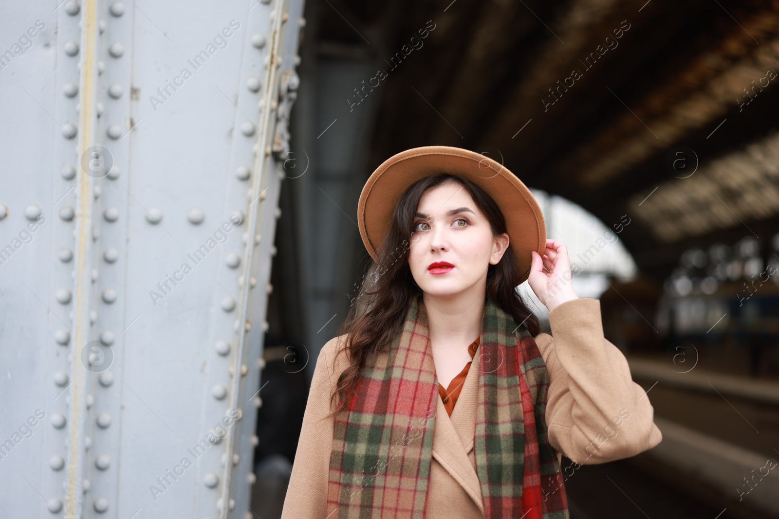 Photo of Beautiful woman in hat at railway station