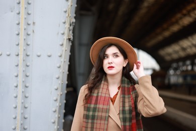 Photo of Beautiful woman in hat at railway station