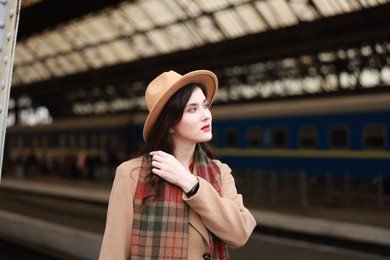 Photo of Beautiful woman in hat at railway station