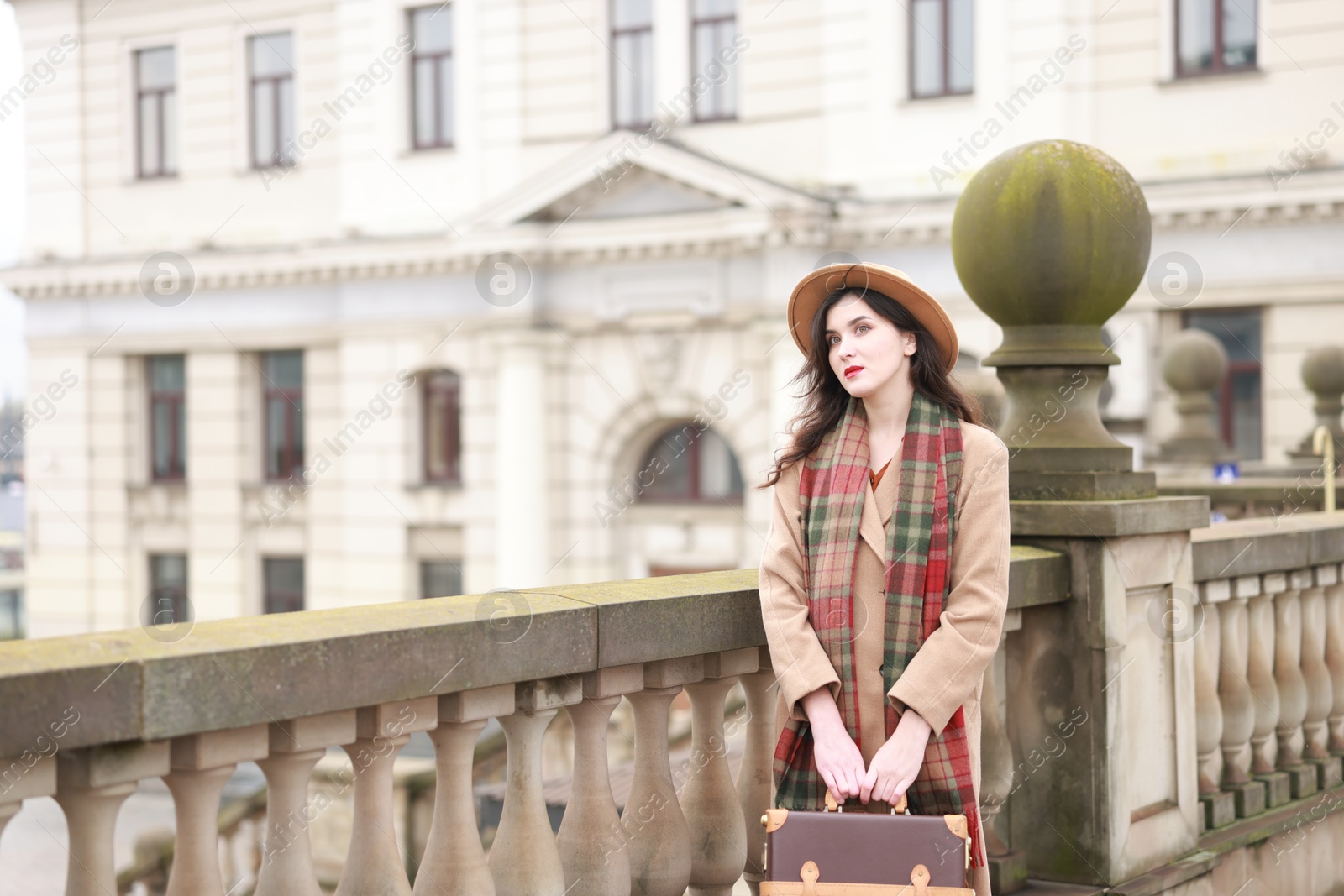 Photo of Woman with suitcase on platform of railway station