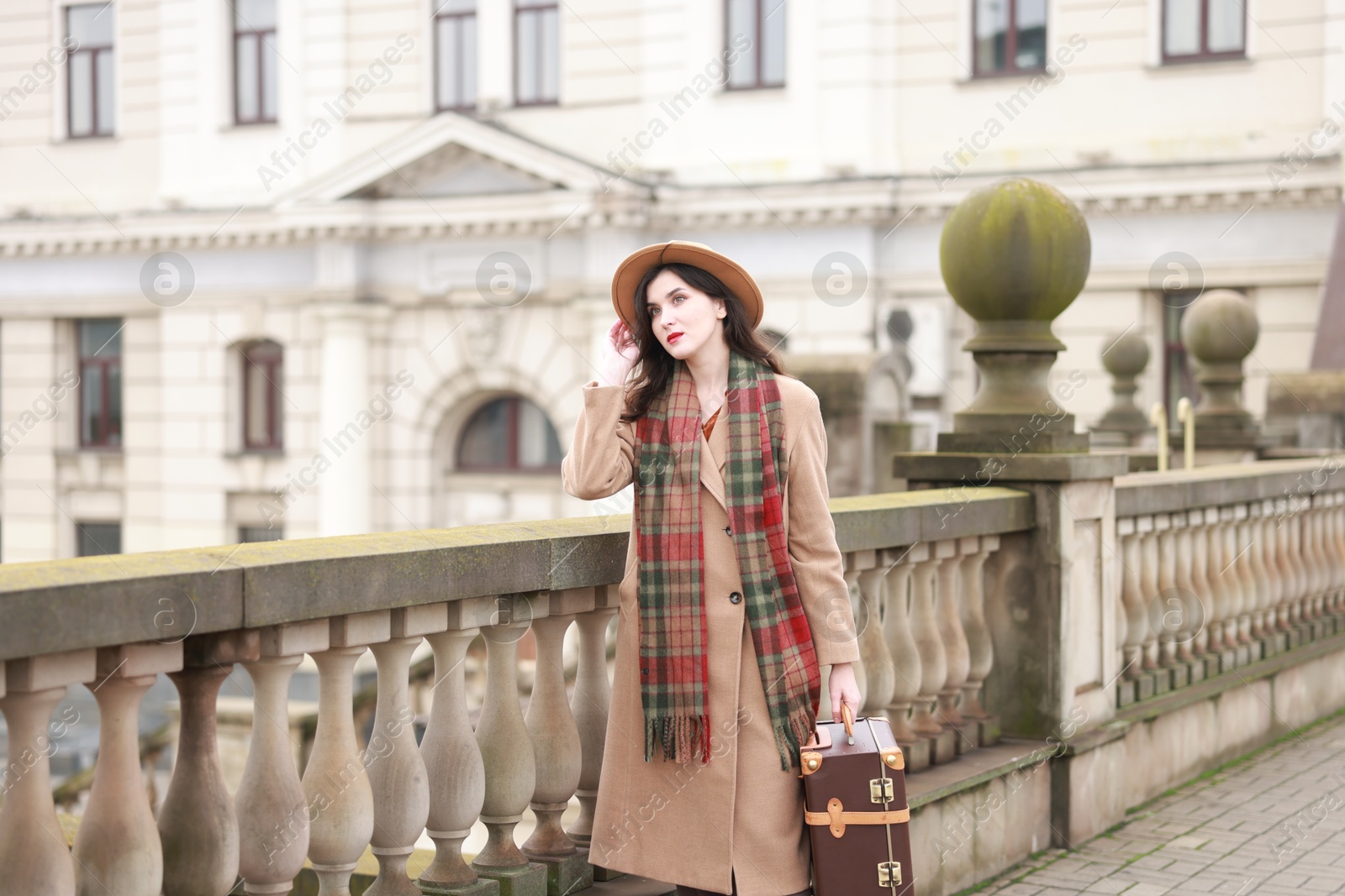 Photo of Woman with suitcase on platform of railway station