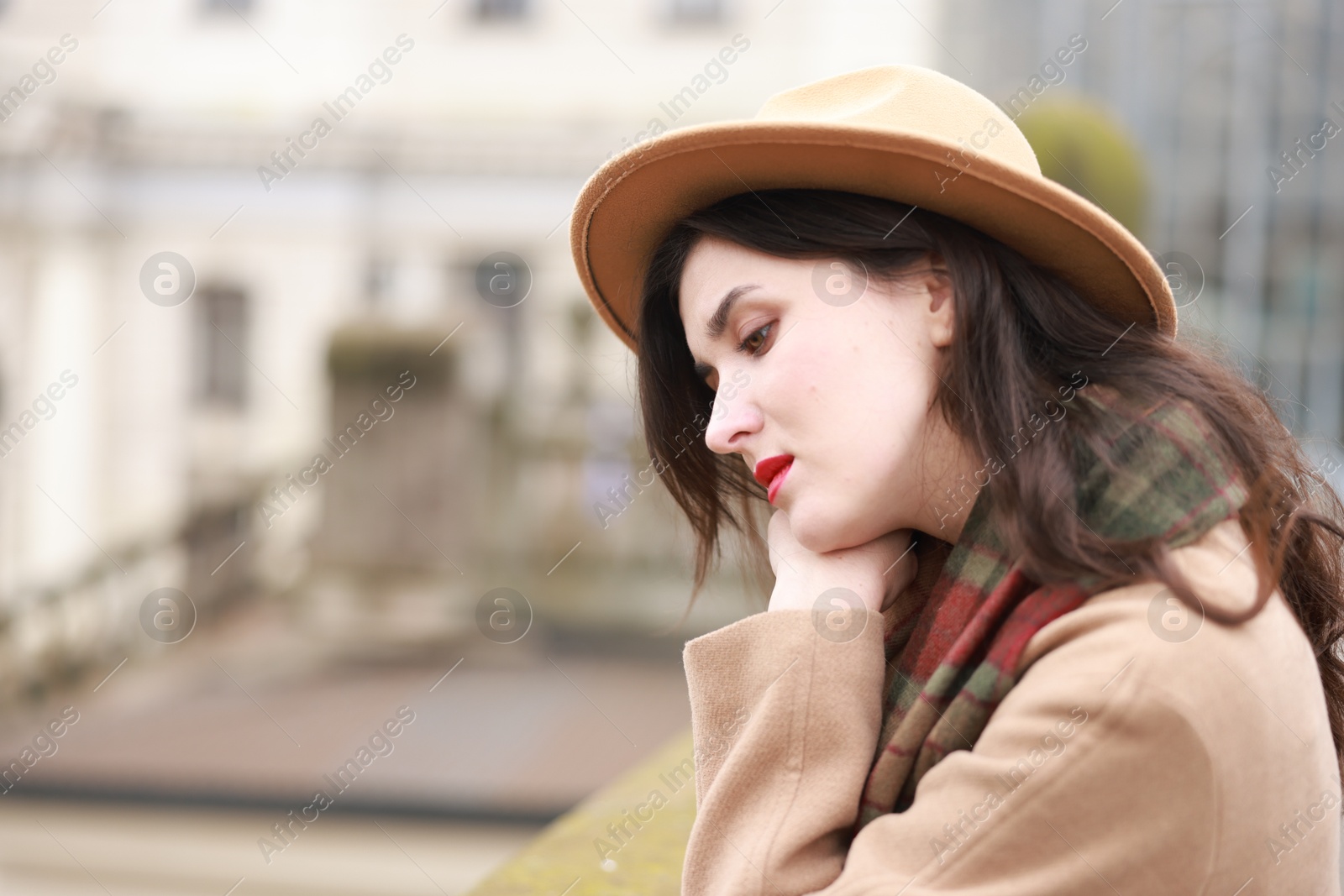 Photo of Beautiful woman in hat and coat outdoors, space for text