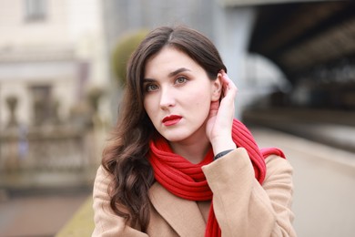 Photo of Woman with red scarf at railway station