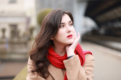 Photo of Woman with red scarf at railway station