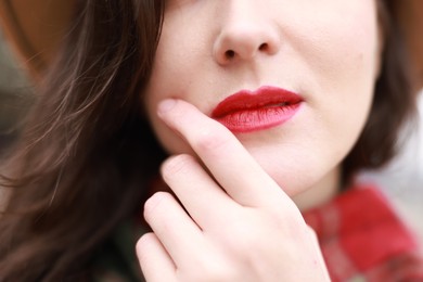 Photo of Woman with red lips outdoors, closeup view