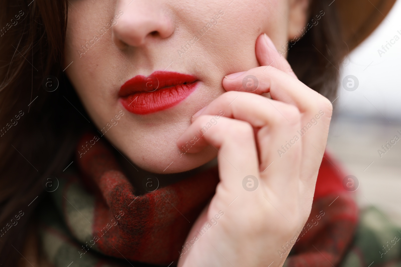 Photo of Woman with red lips outdoors, closeup view