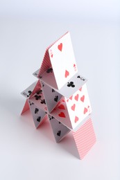 House of playing cards on white background