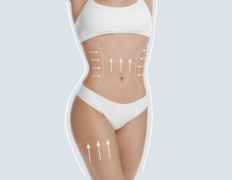 Woman with perfect slim body on white background, closeup. Figure correction arrows and lines on skin