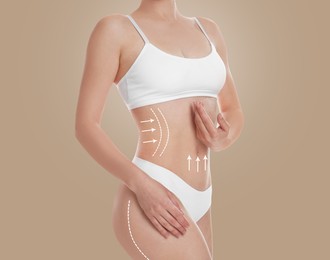 Woman with perfect slim body on dark beige background, closeup. Figure correction arrows and lines on skin