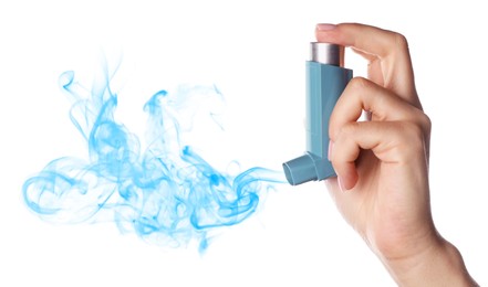 Asthma treatment. Woman holding inhaler on white background, closeup. Aerosolized medication coming out of device