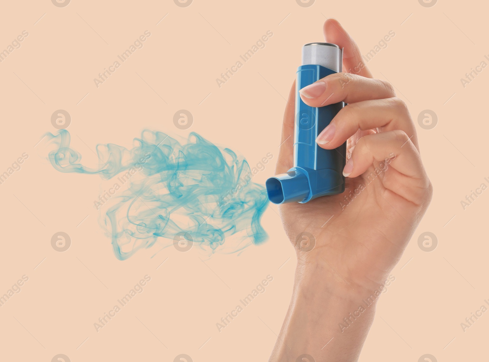 Image of Asthma treatment. Woman holding inhaler on beige background, closeup. Aerosolized medication coming out of device