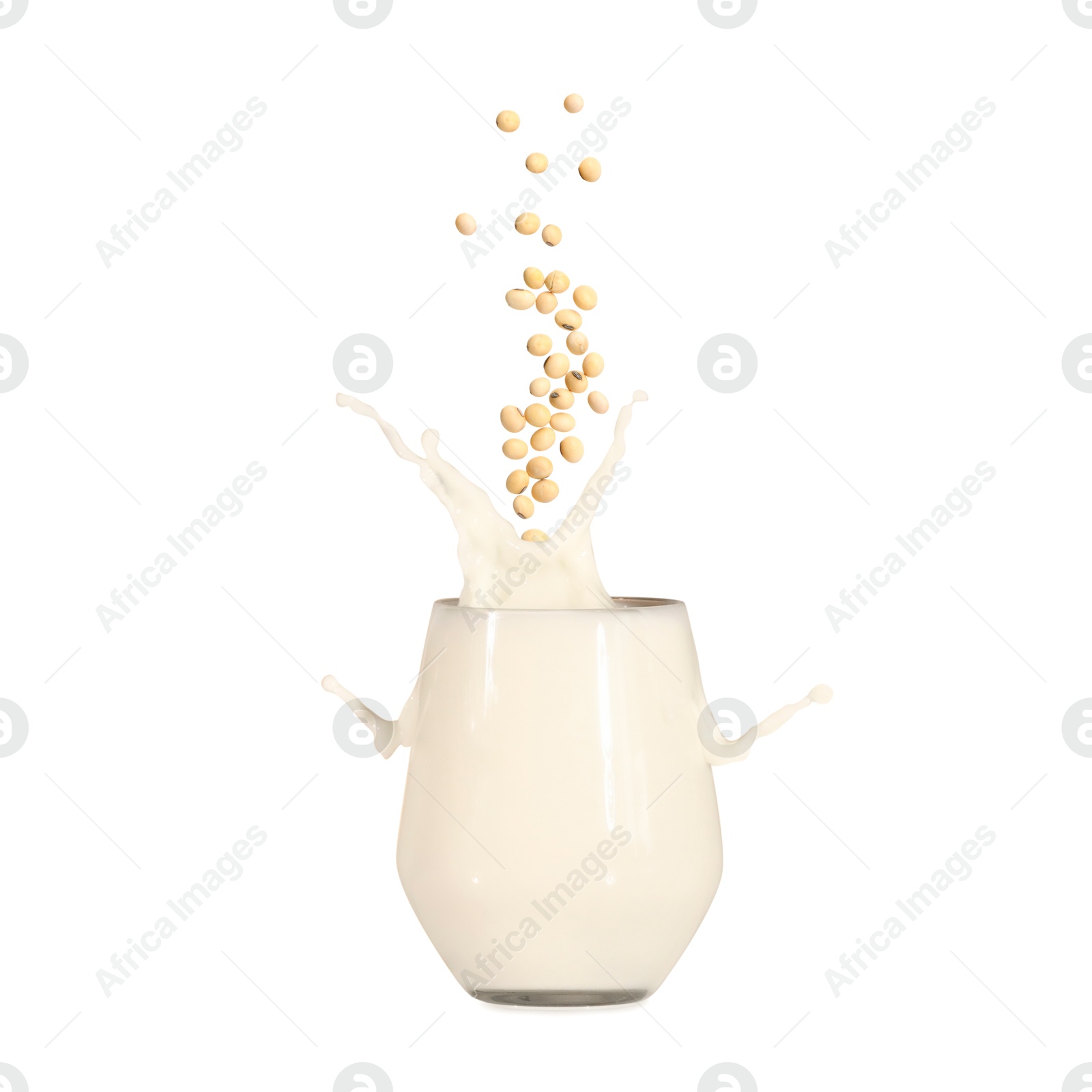 Image of Soy beans falling into glass of plant milk on white background