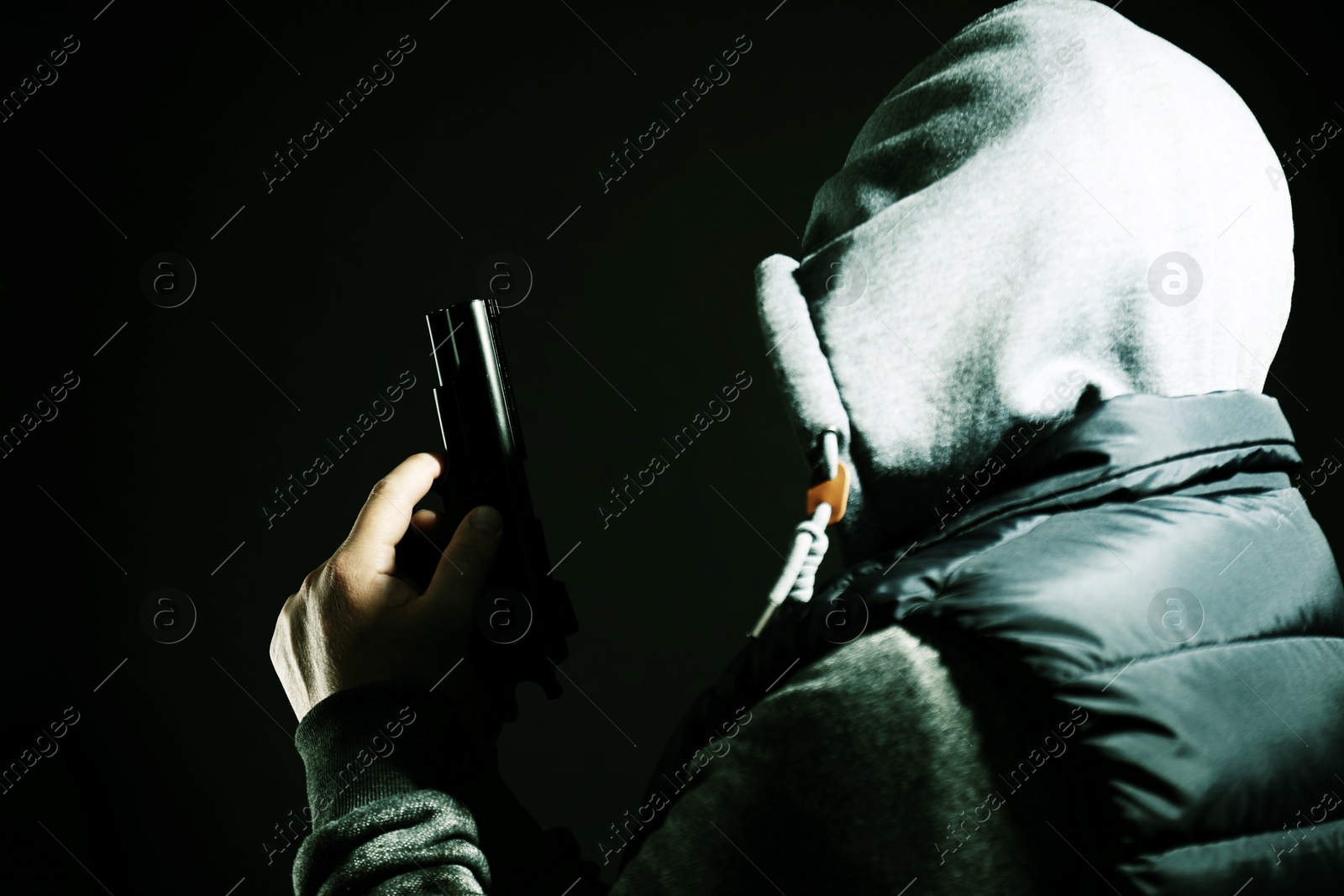 Image of Dangerous criminal with gun on black background. Armed robbery