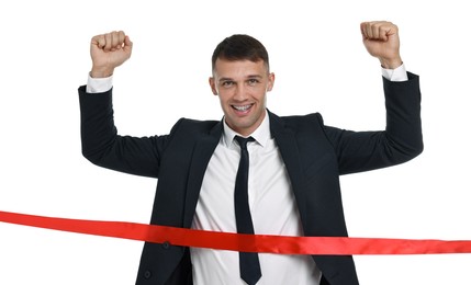 Businessman in suit crossing red finish line on white background