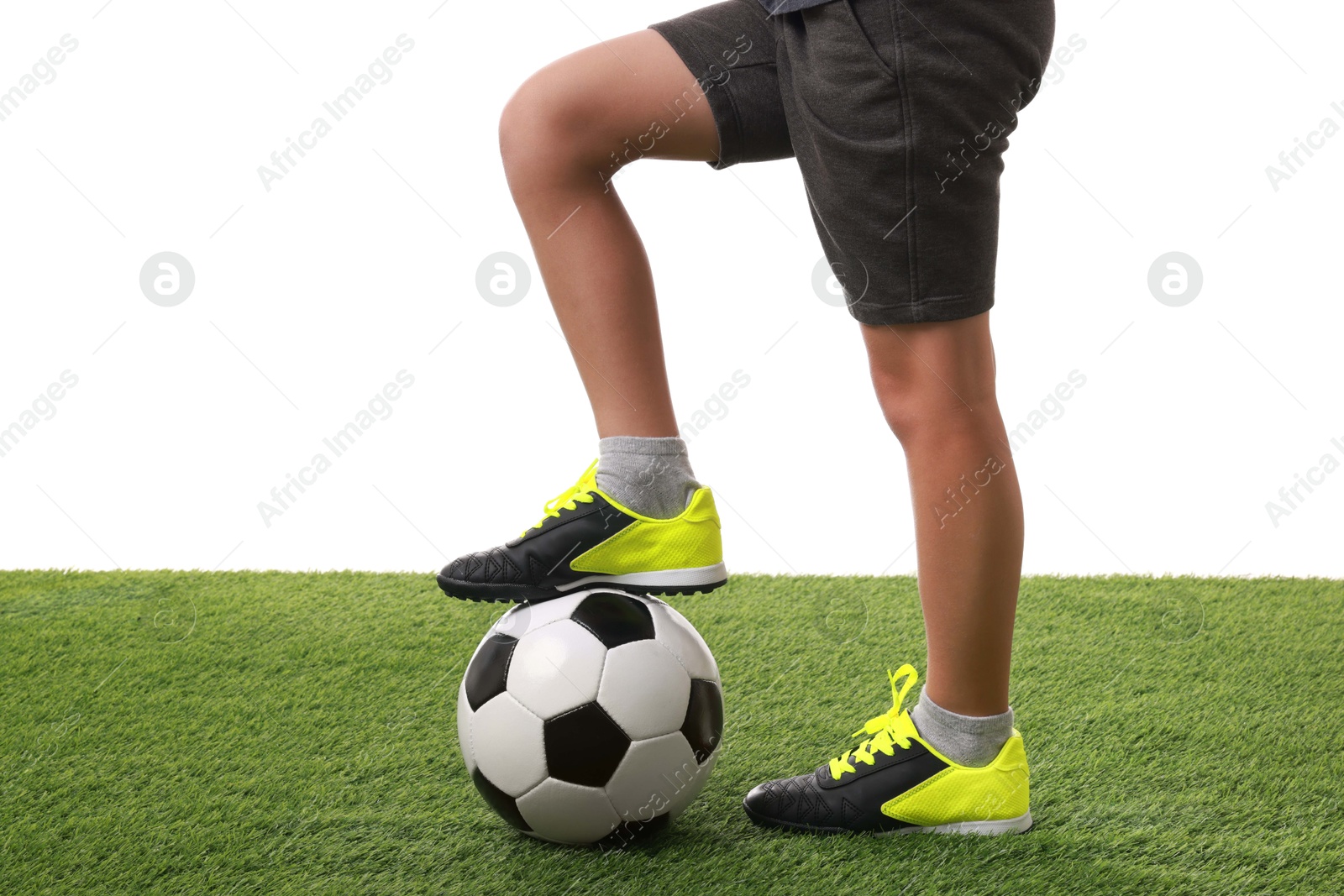 Photo of Football player with soccer ball on artificial grass against white background, closeup