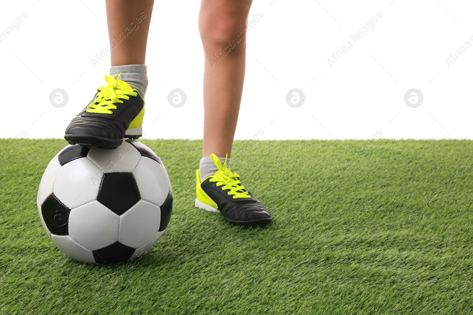 Photo of Football player with soccer ball on artificial grass against white background, closeup. Space for text