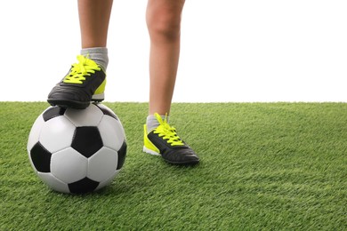 Football player with soccer ball on artificial grass against white background, closeup. Space for text