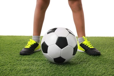 Football player with soccer ball on artificial grass against white background, closeup